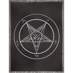May include: Black throw blanket featuring a white pentagram symbol with a goat-like head inside a circle. The blanket has a fringed edge and a textured appearance. The design is centered on the blanket.
