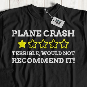 May include: Black t-shirt with a white graphic that says "PLANE CRASH" with a one-star rating and the text "TERRIBLE, WOULD NOT RECOMMEND IT!"