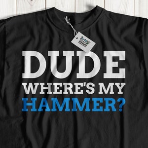 May include: Black t-shirt with white text that reads "DUDE WHERE'S MY HAMMER?" The text "HAMMER" is in blue.