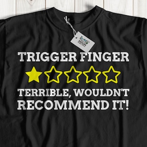May include: Black t-shirt with white text that reads "TRIGGER FINGER TERRIBLE, WOULDN'T RECOMMEND IT!" and five yellow stars.