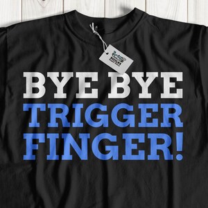 May include: Black t-shirt with the text "BYE BYE TRIGGER FINGER!" in white and blue lettering.
