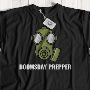 May include: Black t-shirt featuring a green gas mask graphic and the text "DOOMSDAY PREPPER" in white.