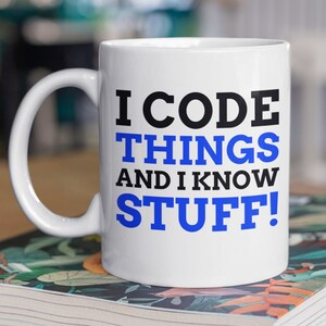 May include: White ceramic mug with a black and blue design. The mug says "I code things and I know stuff!"