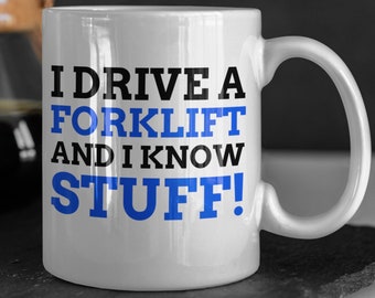 May include: White ceramic coffee mug with a blue and black graphic that reads "I drive a forklift and I know stuff!"