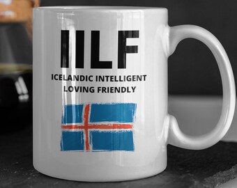 May include: White ceramic mug with a black and white graphic that says "ILF Icelandic Intelligent Loving Friendly" and a blue and red Icelandic flag.
