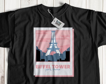 Puede incluir: Camiseta negra con un gráfico rosa y azul de la Torre Eiffel en París, Francia. El gráfico incluye el texto "Eiffel Tower" y "Paris, France".