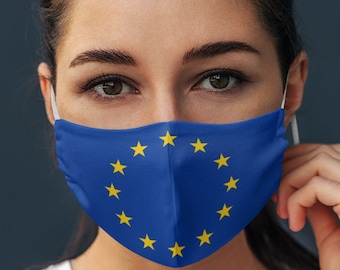 May include: A person wearing a blue face mask with a circle of yellow stars, resembling the European Union flag.