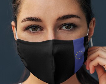 May include: A person wearing a black face mask with a blue and yellow European Union flag design.