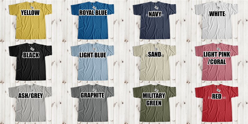 May include: A collage of 12 t-shirts in various colors, including yellow, royal blue, navy, white, black, light blue, sand, light pink/coral, ash/grey, graphite, military green, and red. Each t-shirt has a different color and is displayed on a white wooden background.