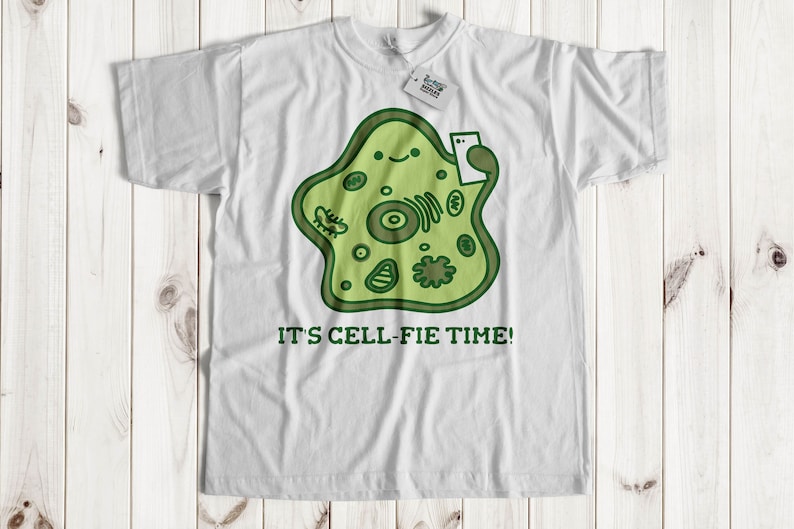 May include: White t-shirt with a green cartoon cell holding a phone and the text "It's Cell-fie Time!"
