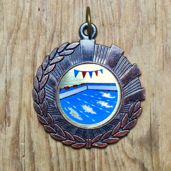 Vintage sport swimming medal of award.