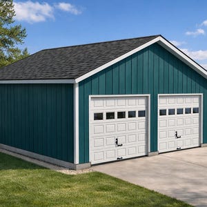 May include: A teal-colored two-car garage with white trim and two white garage doors. The roof is dark gray, and the building sits on a concrete driveway with a green lawn in front. The sky is blue with some clouds.