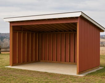 May include: A red wooden shed with white roof trim stands on a grassy field. The open-sided structure has a concrete floor and is framed with vertical wooden beams. The background features a rural landscape under a cloudy sky.
