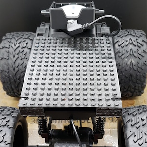 3D Printed Bed/Battery holder for WYZE Car to accept building blocks.  WYZE Car/Cam/Battery/Wheels/Building Blocks not included.