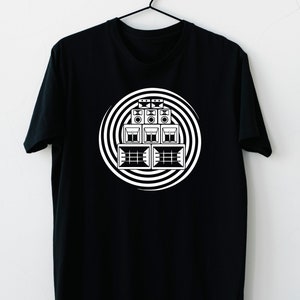 May include: Black t-shirt featuring a white graphic of a stack of speakers in a circular pattern.