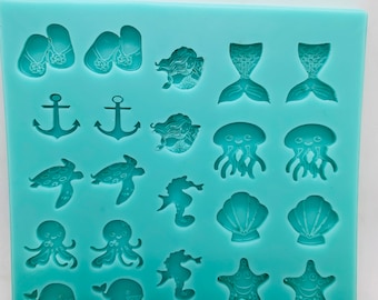 May include: A turquoise silicone mold with 18 different shapes for making resin crafts. The shapes include mermaids, seashells, starfish, anchors, jellyfish, seahorses, and more.