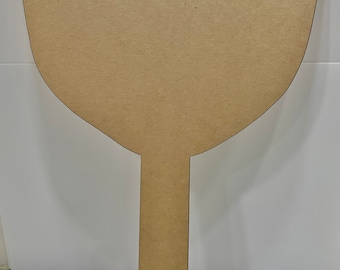 May include: A brown wooden cutout of a fan with a handle. The fan is shaped like a large teardrop with a rounded top and a pointed bottom. The handle is long and straight.