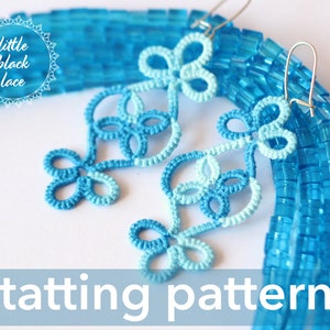 May include: A pair of blue and light blue crocheted earrings with a tatting pattern. The earrings are hanging from silver hooks. The text "little black lace" is visible in the image.