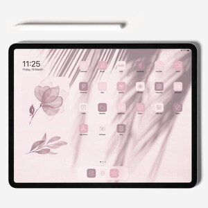 May include: A pink iPad with a white stylus on a white surface. The iPad screen displays a pink and white home screen with a variety of app icons, including Calendar, Music, Hulu, Facebook, YouTube, Zoom, Pinterest, Mail, Spotify, Photos, Calendar, Behance, Trello, Weather, Lightroom, Notes, HBO GO, Safari, App Store, Settings, and Etsy. The time is 11:25 and the date is Friday, 19 March.