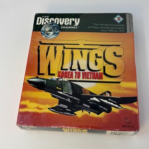 May include: A rectangular box for The Discovery Channel Wings Korea to Vietnam CD-ROM. The cover features a black military aircraft flying against a sunset background, with the title in large yellow letters and a small globe graphic at the top.