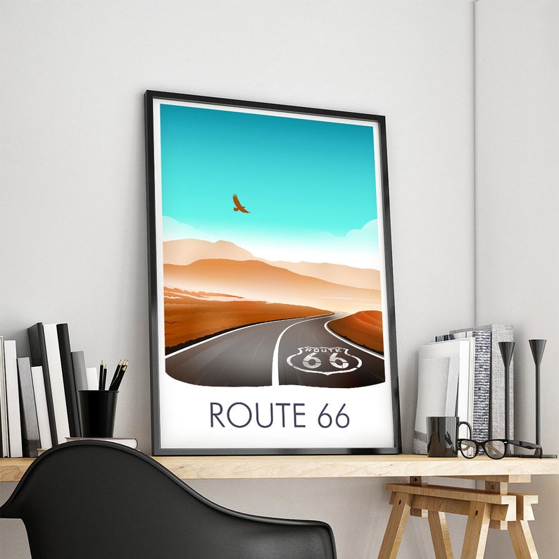 May include: A black framed poster with a blue sky, brown hills, and a road leading to a sign that says "ROUTE 66".