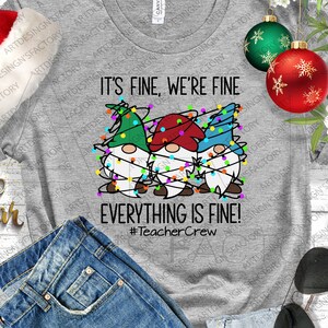 May include: A gray t-shirt with the text "IT'S FINE, WE'RE FINE EVERYTHING IS FINE!" and three gnomes decorated with Christmas lights. The shirt also has the hashtag #TeacherCrew.