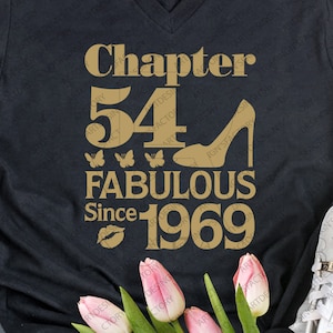 May include: Black t-shirt with gold text that reads "Chapter 54 Fabulous Since 1969". The text is decorated with a gold high heel shoe, butterflies, and a lip print.