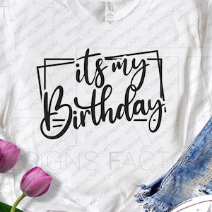May include: White t-shirt with black text that reads "it's my Birthday" in a decorative font.