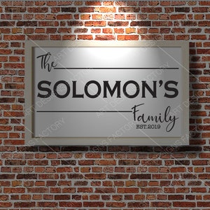 May include: White framed sign with black text that reads "The Solomon's Family Est. 2019".