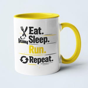 May include: White ceramic mug with a yellow interior and handle. The mug features the text "Eat. Sleep. Run. Repeat." in black and yellow, with related icons. The mug is designed for beverages and is suitable for home or office use.