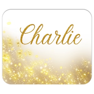 May include: A white background with a gold glitter design and the name "Charlie" written in gold glitter.