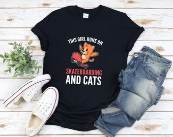 May include: Black t-shirt with a graphic of a cat skateboarding and the text "This girl runs on skateboarding and cats".