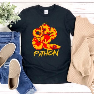 May include: Black t-shirt with a red and yellow python graphic and the word "PYTHON" in yellow letters.
