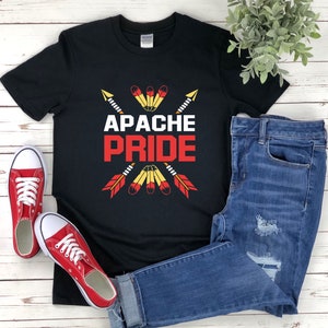 May include: Black t-shirt with a graphic of crossed arrows and the text "Apache Pride" in red letters.