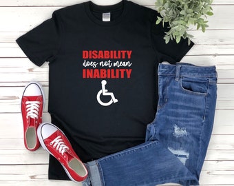 May include: Black t-shirt with the text "DISABILITY does not mean INABILITY" in red letters and a white wheelchair symbol.