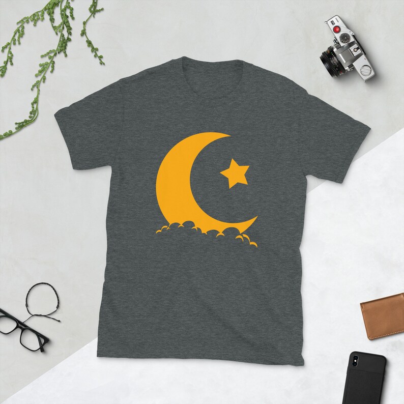 May include: A dark heather grey t-shirt with a yellow crescent moon and star graphic.