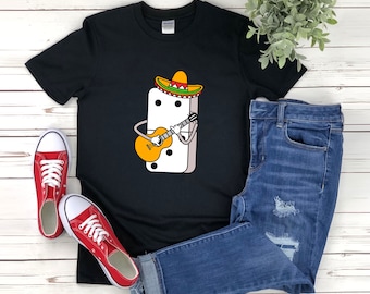May include: Black t-shirt with a white domino wearing a sombrero and playing a guitar. The domino has black dots on it.
