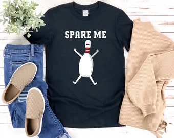 May include: Black t-shirt with the text "Spare Me" and a cartoon bowling pin with a red and white stripe.
