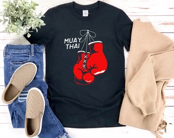 May include: Black t-shirt with a white graphic of boxing gloves and the text "MUAY THAI".