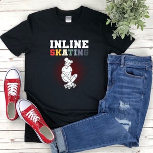 May include: Black t-shirt with the text "INLINE SKATING" in rainbow colours and a white illustration of a person inline skating.
