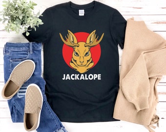May include: Black t-shirt with a red circle and a jackalope illustration. The text "JACKALOPE" is printed in white below the illustration.