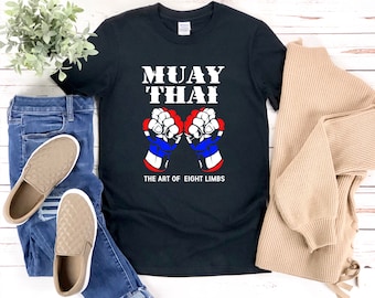May include: Black t-shirt with the text "Muay Thai" and a graphic of two fists with the text "The Art of Eight Limbs".