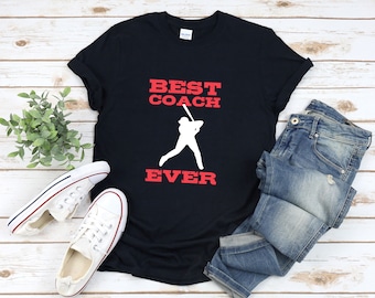 May include: A black t-shirt with the text "BEST COACH EVER" in red and white. A white silhouette of a baseball player is in the center of the shirt.