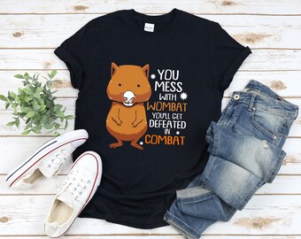 May include: A black t-shirt featuring a cartoon wombat and the text "You mess with wombat you'll get defeated in combat".