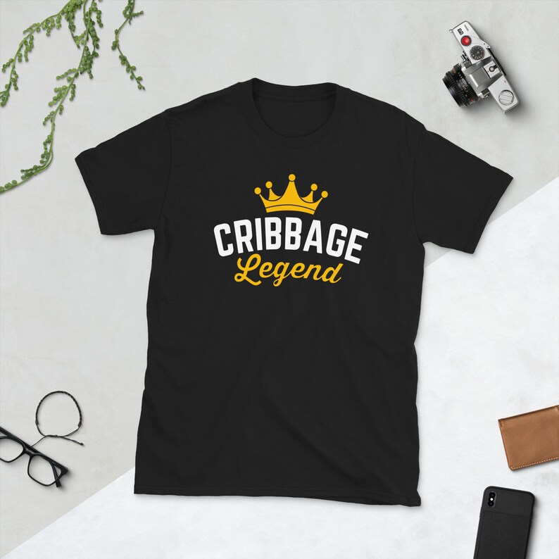 May include: Black t-shirt with a white crown and the text "Cribbage Legend" in yellow.