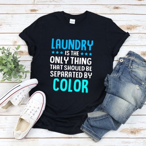 May include: Black t-shirt with white text that reads "Laundry is the only thing that should be separated by color" in blue text.