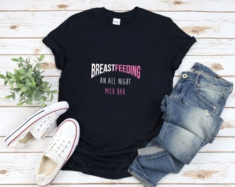 May include: Black t-shirt with the text "BREASTFEEDING AN ALL NIGHT MILK BAR" in pink letters.
