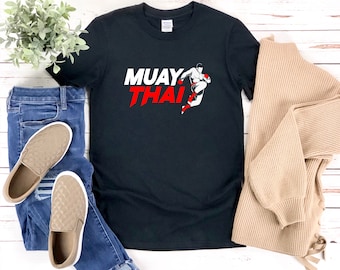 May include: Black t-shirt with a white graphic of a Muay Thai fighter and the text "MUAY THAI" in red and white.