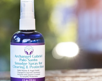 May include: A blue glass bottle with a white spray nozzle, labelled "Archangel Gabriel Palo Santo Smudge Spray for Clearing & Protection". The bottle is 4 fluid ounces (118 ml) and is infused with quartz crystals to amplify protection.