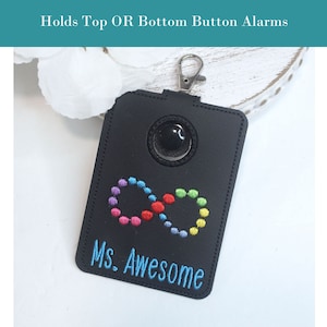 May include: Black leather keychain with a clear plastic window, an infinity symbol with rainbow colored dots, and the text "Ms. Awesome" embroidered in blue thread.